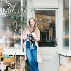 Cotswold Branding Photographer Emma Jackson holds a camera and smiles
